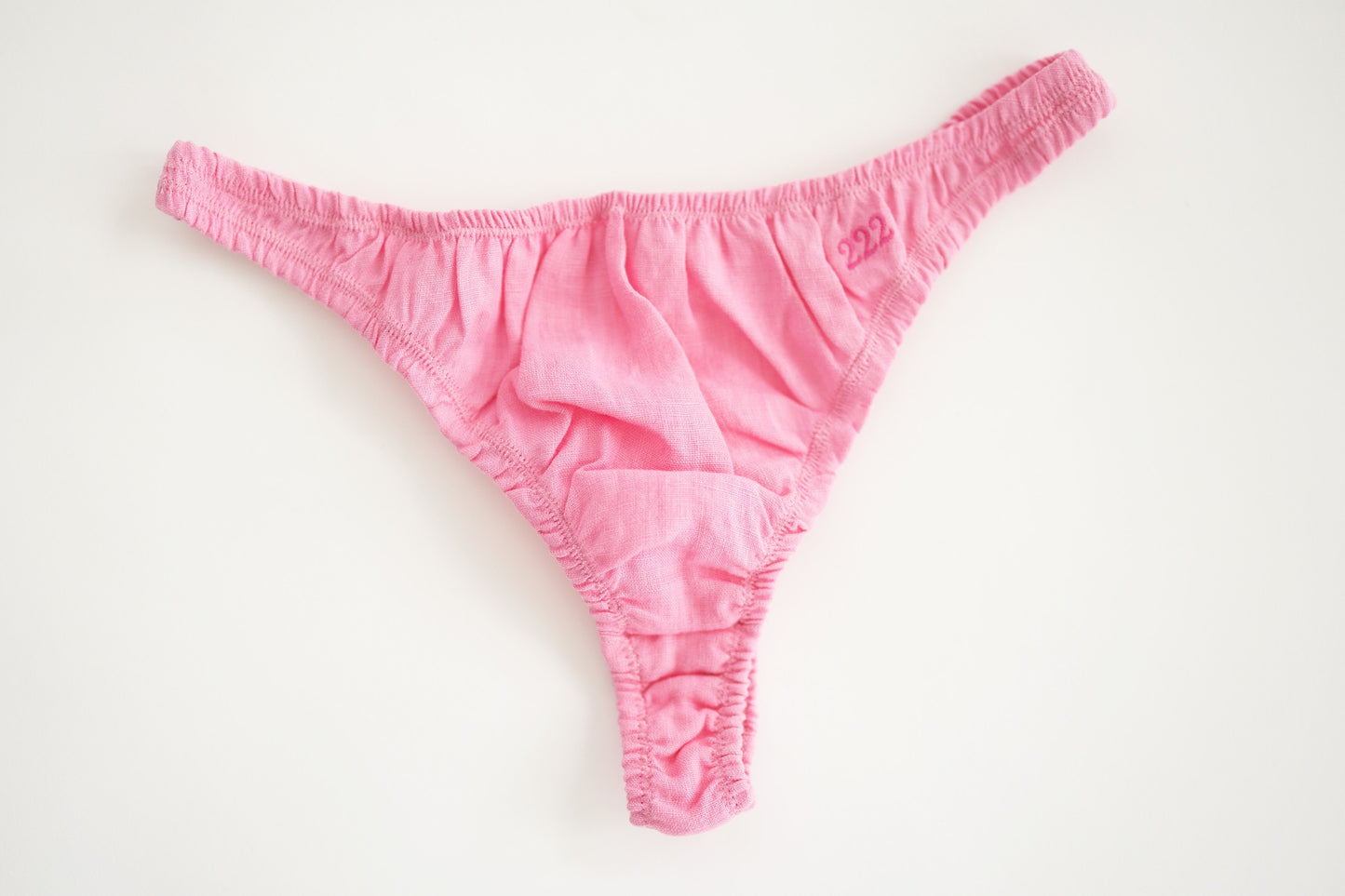 Pink linen thong shot from the front showing size and detail