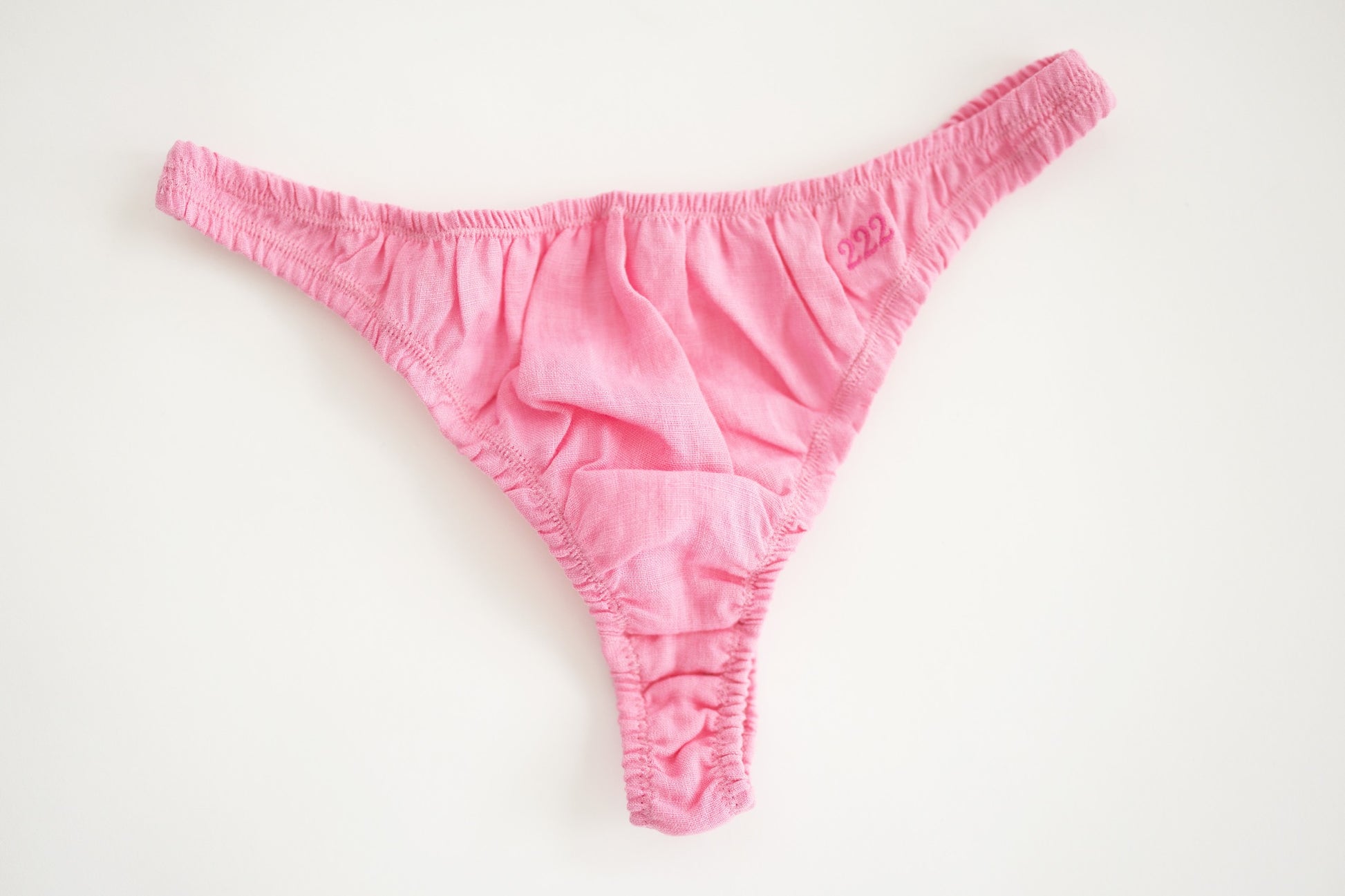 Pink linen thong shot from the front showing size and detail